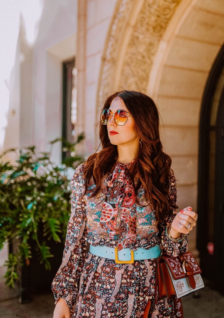 Girl wearing paisley dress and sunglasses