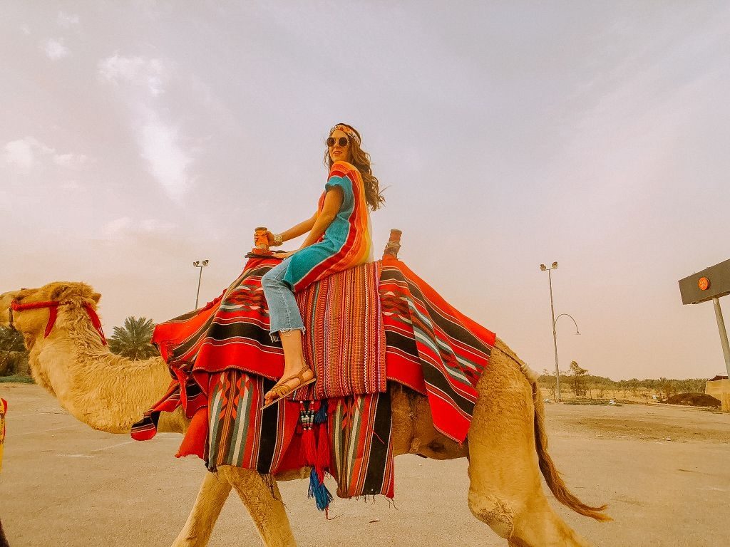 girl riding camel in the judean desert Israel