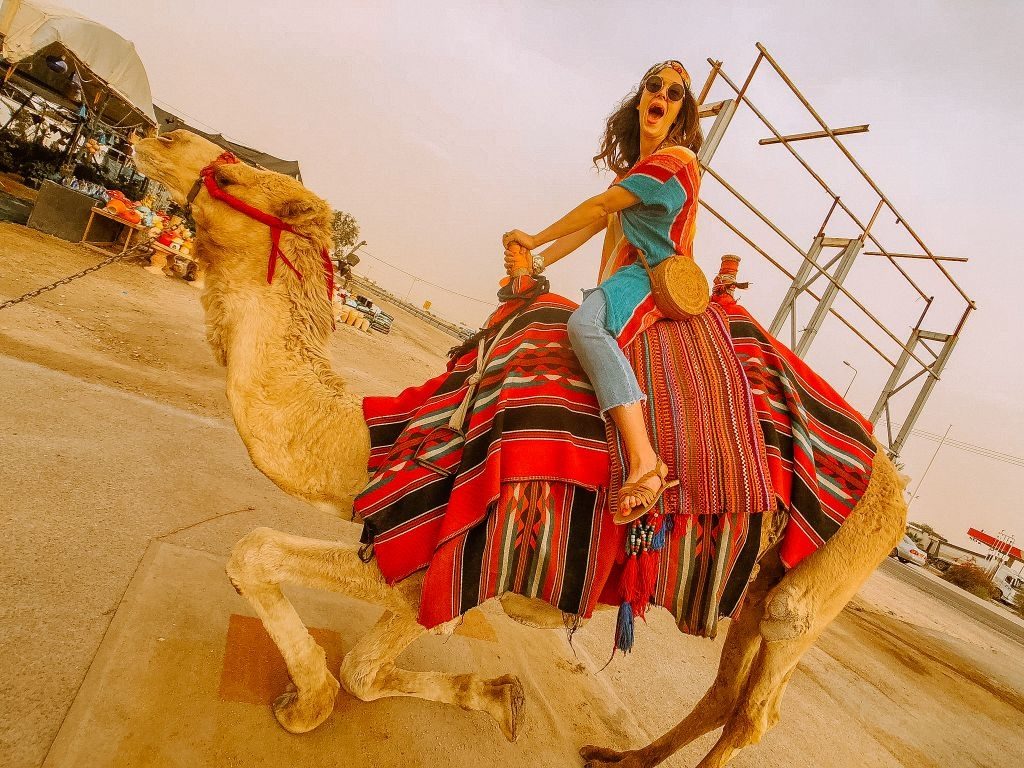 girl riding camel in the judean desert Israel