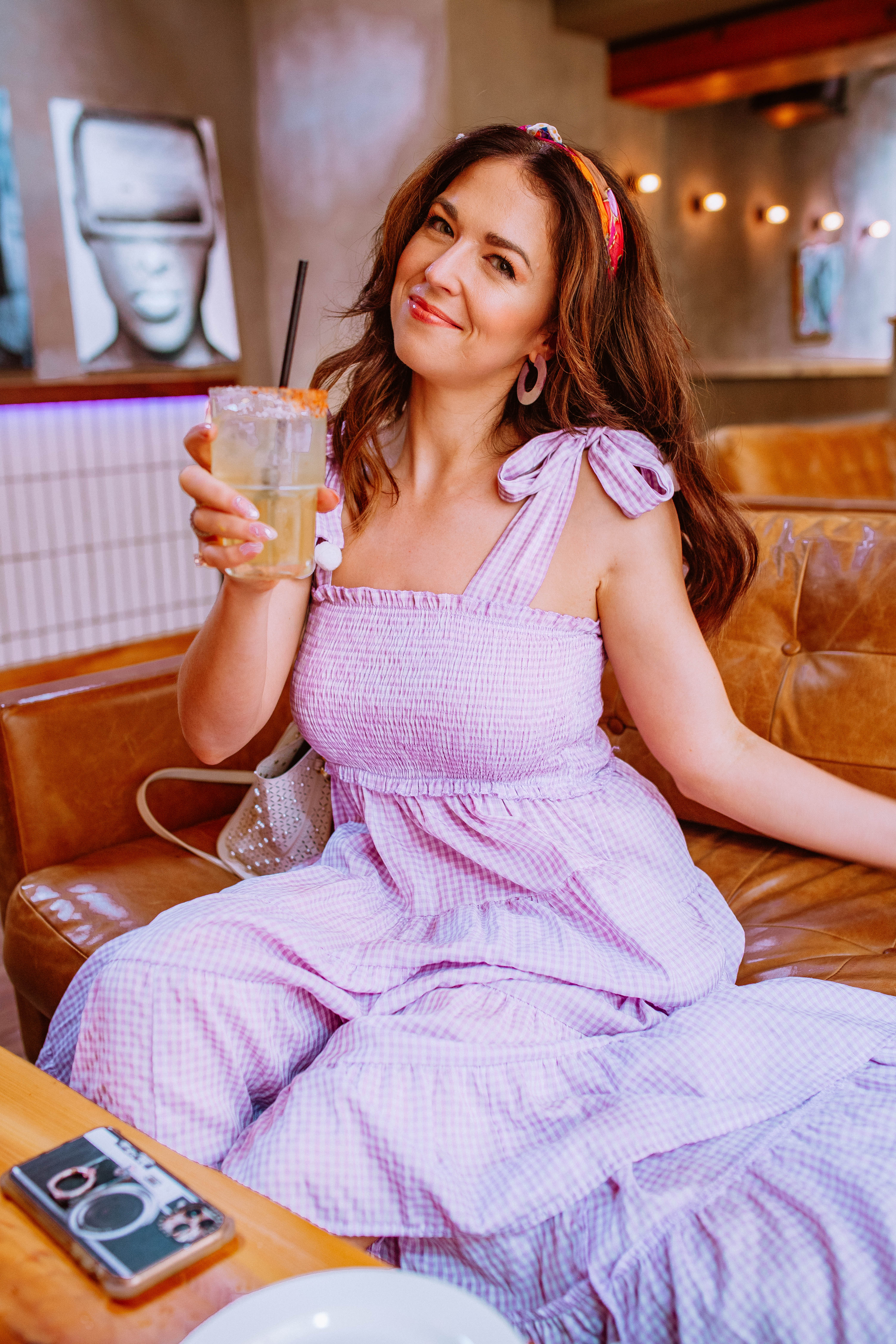 Girl holding a margarita eating brunch at Pilsen Yards Chicago