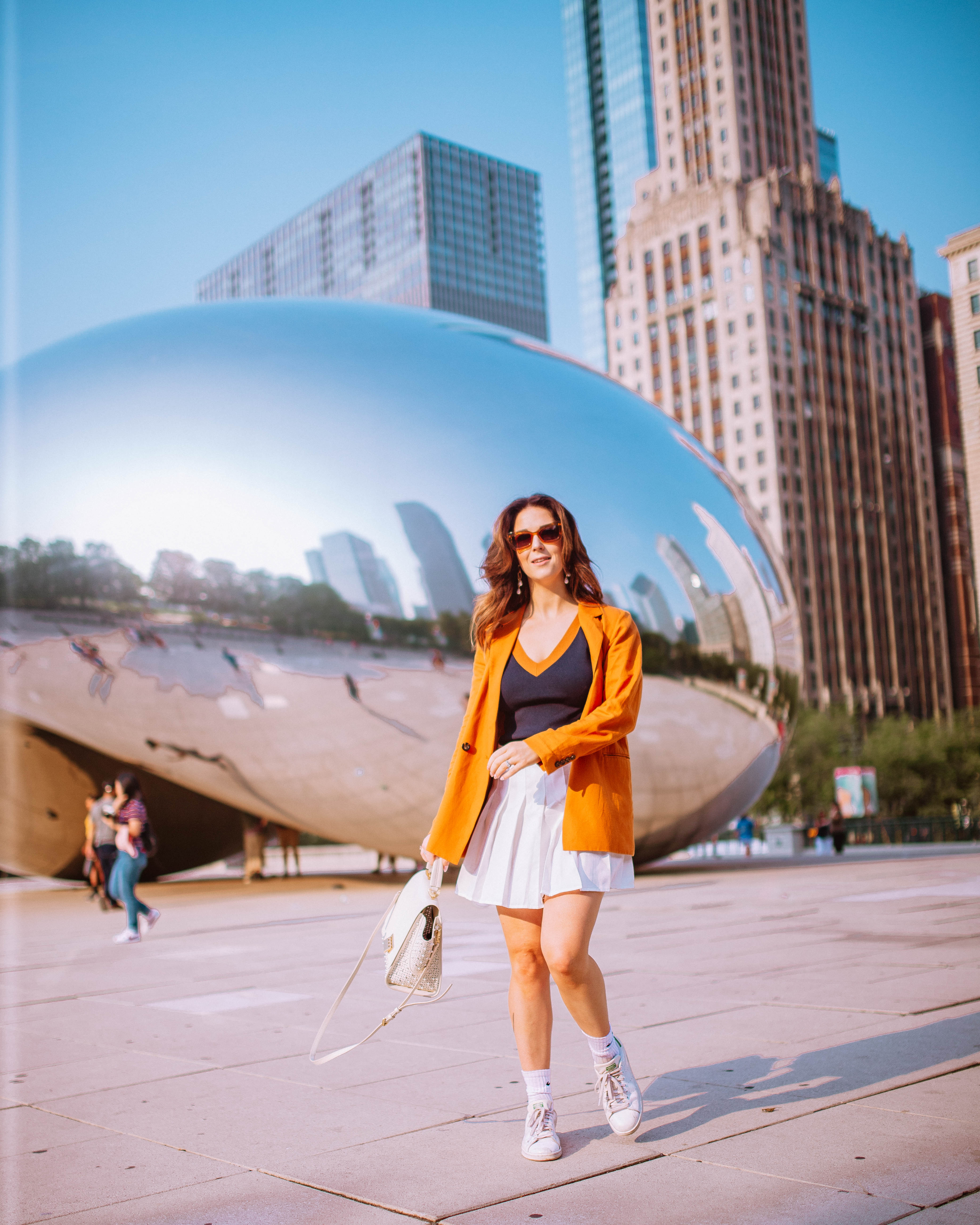 girl posing in reflection of the bean in millennium park, chicago