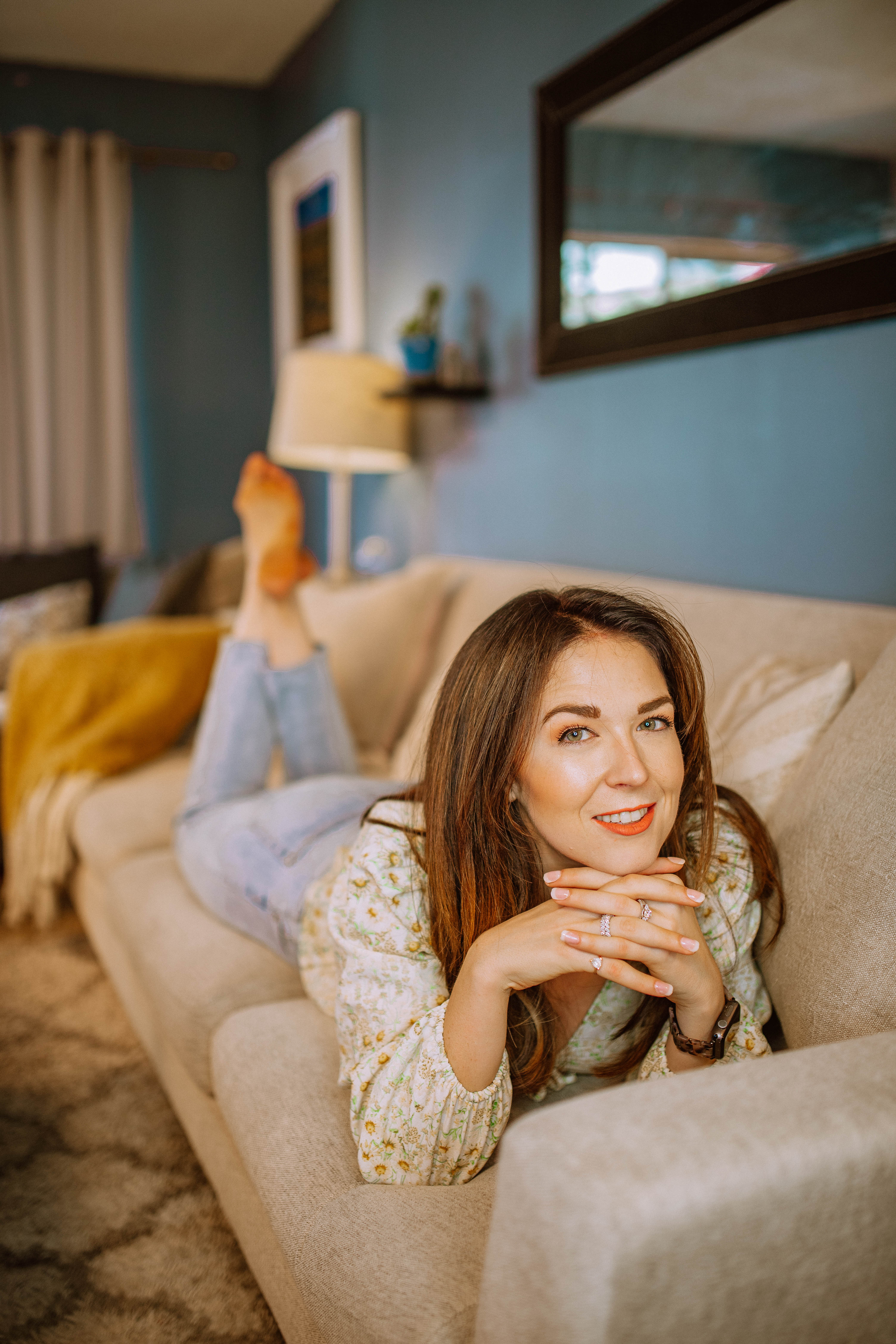 girl lounging on joybird couch. If you're thinking of buying a Joybird, check out my Joybird couch review first!