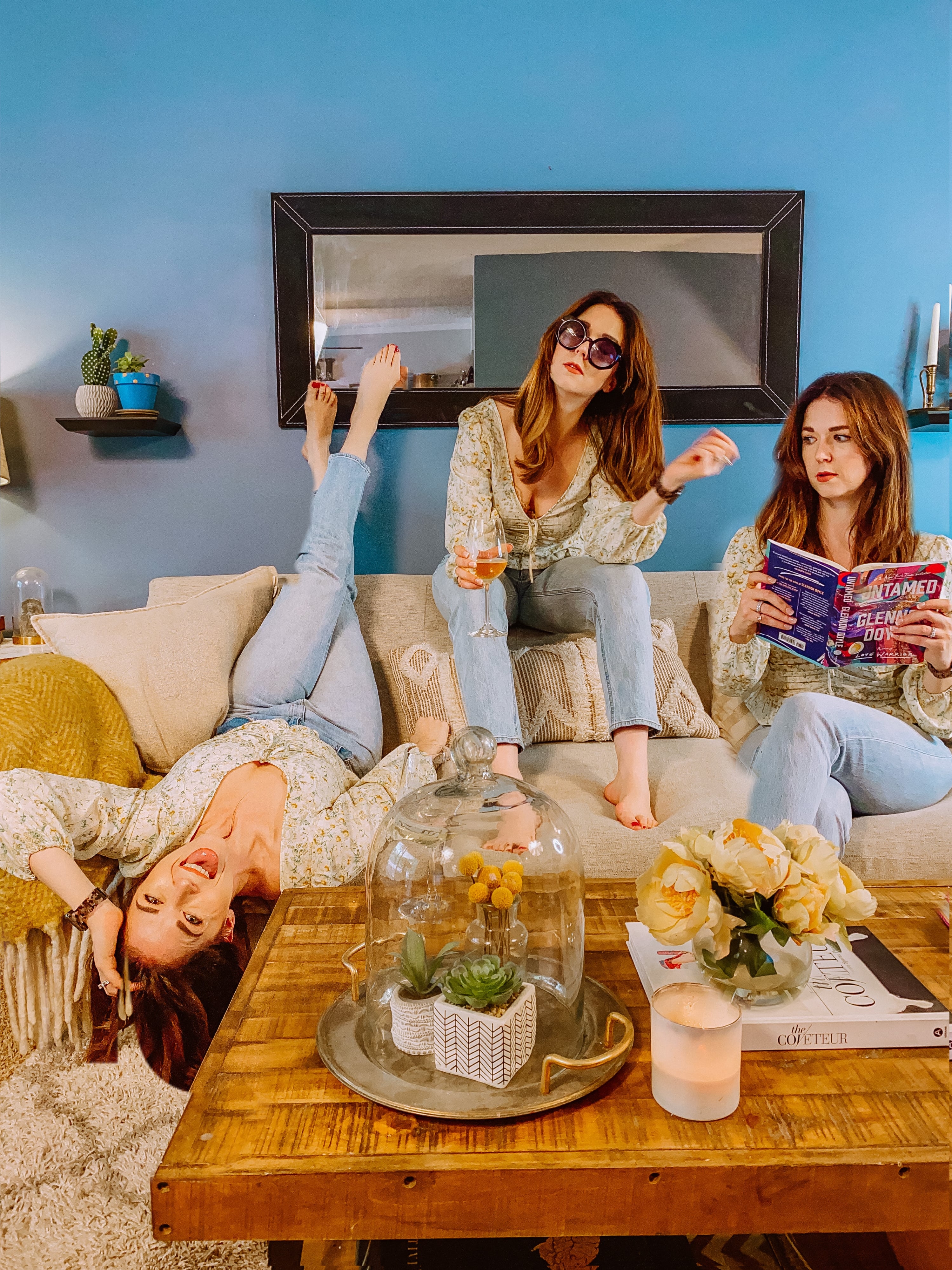 Three women sitting on a joybird hughes grand sofa in merit dove